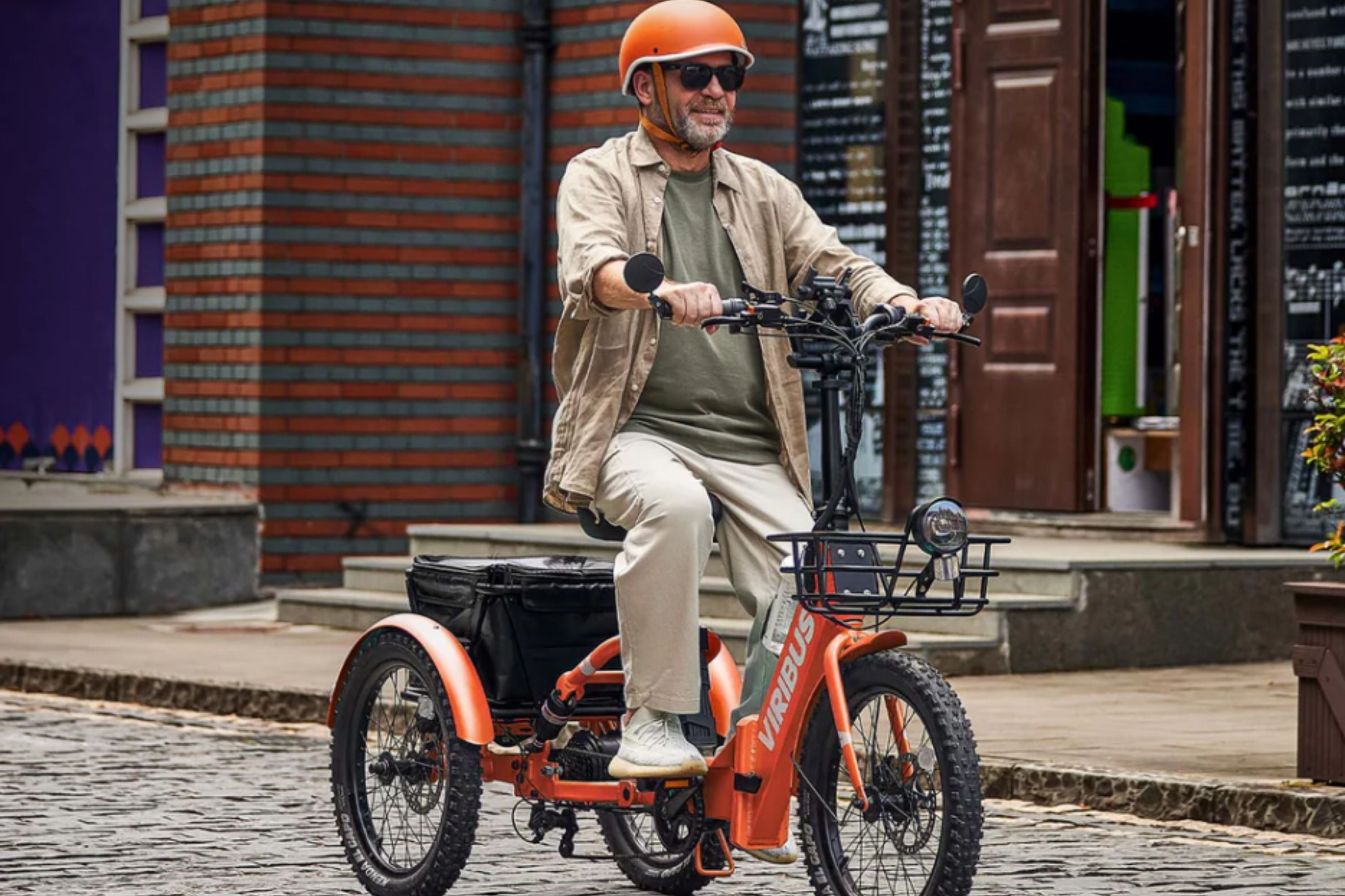 an adult gentleman riding a folding electric tricycle through an urban area