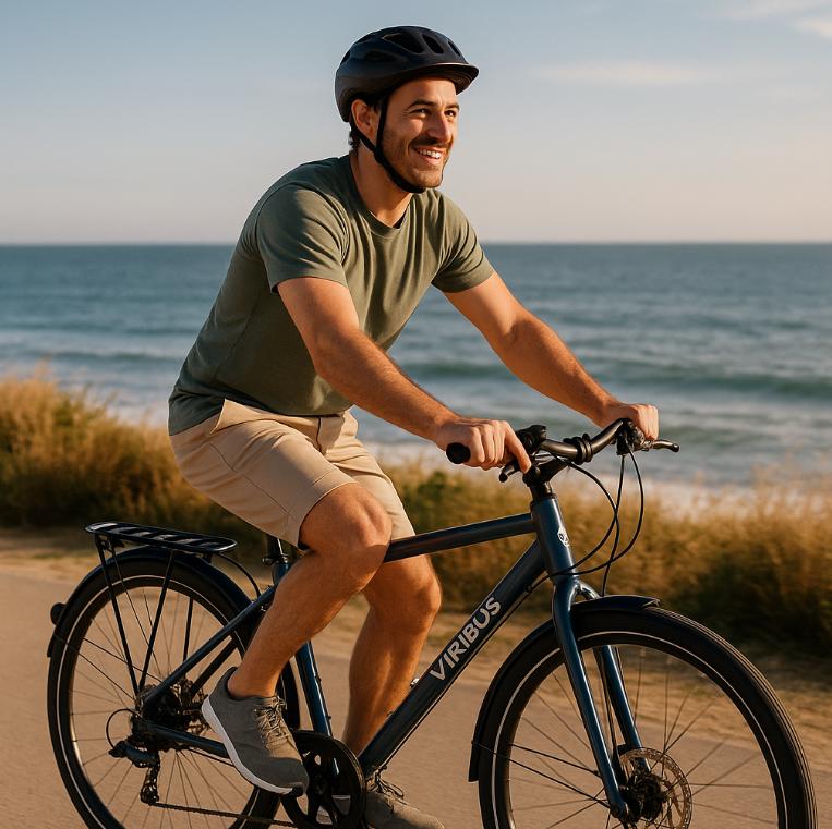 Man riding a bicycle on a path by the ocean