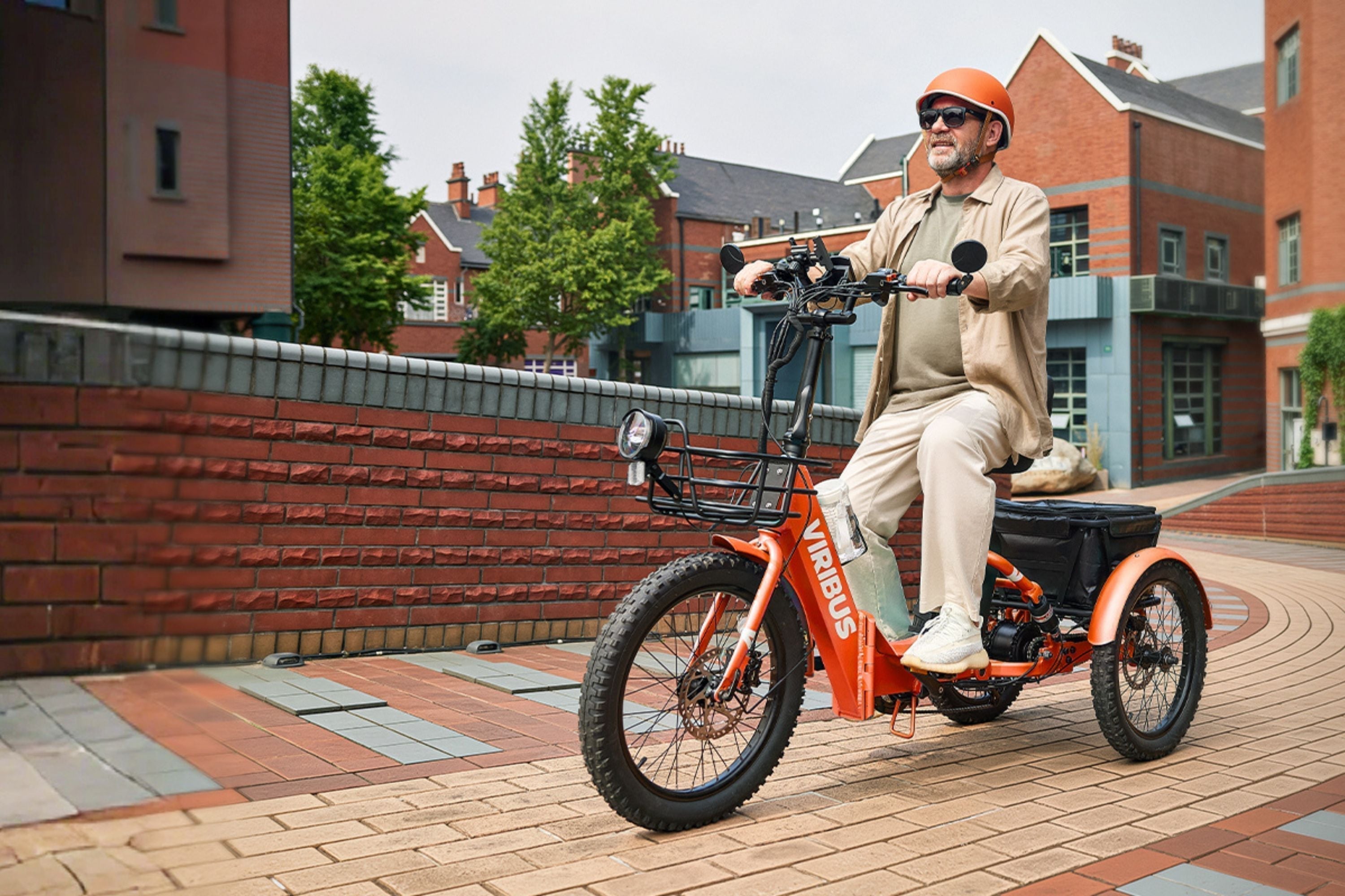 a man riding a fat tire electric tricycle on an urban road